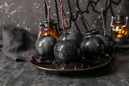 Photo for Plate of tasty caramel apples for Halloween on black background - Royalty Free Image