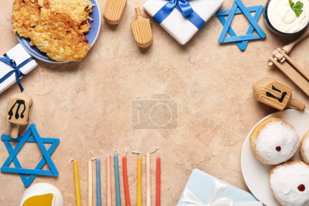 Photo for Frame made from different Hannukah symbols on beige table - Royalty Free Image