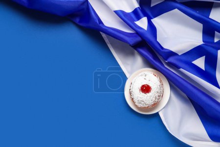 Photo for Hanukkah composition with donut and flag of Israel on blue background - Royalty Free Image