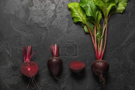 Fresh beets with green leaves on black background-stock-photo