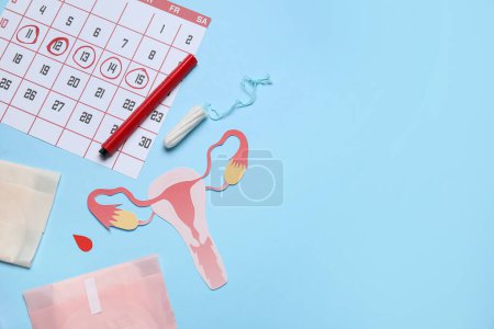 Photo for Composition with paper uterus, menstrual calendar and feminine hygiene products on color background - Royalty Free Image