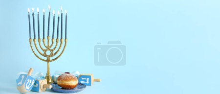 Photo for Hanukkiah with gifts, dreidels and donut on light blue background with space for text. Hanukkah celebration - Royalty Free Image