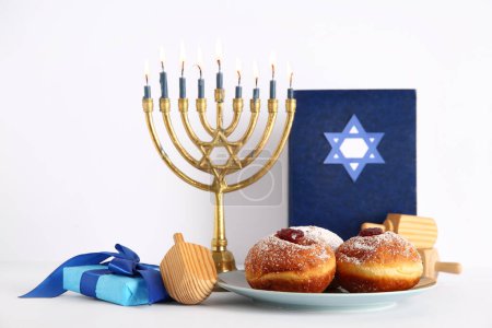 Photo for Menorah with dreidels, gift box, tasty donuts and Torah isolated on white background. Hanukkah celebration - Royalty Free Image