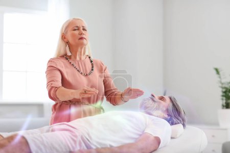 Photo for Female Reiki master healing patient - Royalty Free Image
