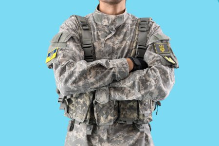 Photo for Male soldier with Ukrainian chevrons on blue background - Royalty Free Image