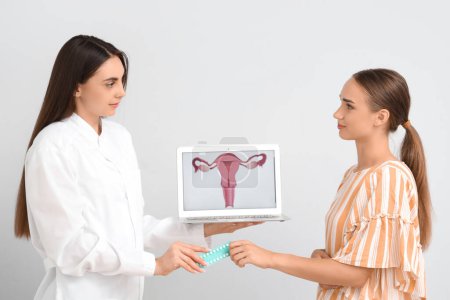 Female gynecologist giving contraceptive pills to patient on light background