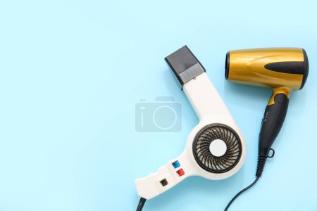 Photo for Hair dryers on light blue background - Royalty Free Image