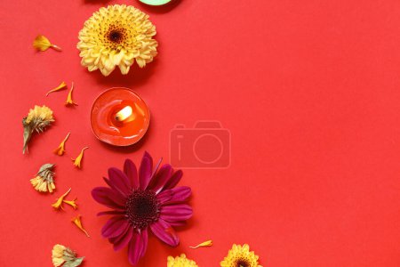 Photo for Burning candle with beautiful flowers on red background. Divaly celebration - Royalty Free Image