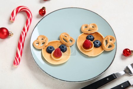 Photo for Plate with pancakes in shape of reindeers on white background. Christmas celebration - Royalty Free Image