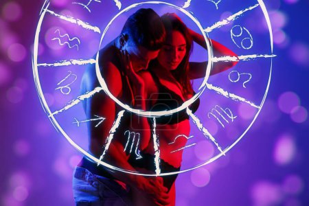 Photo for Passionate young couple and Zodiac wheel on color background. Sexual compatibility horoscope - Royalty Free Image
