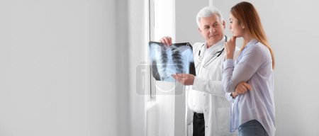 Photo for Senior doctor with x-ray image of lungs and female patient in clinic. Banner for design - Royalty Free Image