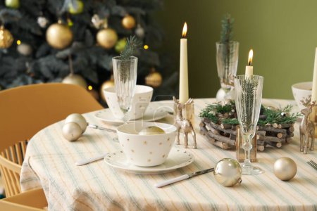 Photo for Festive table setting with Christmas decorations, reindeers and burning candles, closeup - Royalty Free Image