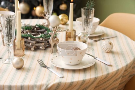 Photo for Festive table setting with Christmas decorations, reindeers and burning candles, closeup - Royalty Free Image