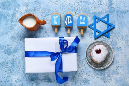 Photo for Composition with gift box and traditional symbols for Hanukkah celebration on color background - Royalty Free Image