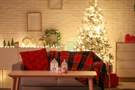 Photo for Interior of stylish living room with beautiful Christmas tree and gift boxes at night - Royalty Free Image