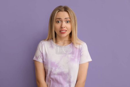 Photo for Young woman feeling shame on lilac background - Royalty Free Image
