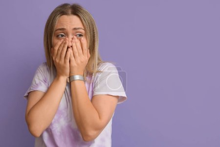 Photo for Embarrassed young woman on lilac background - Royalty Free Image