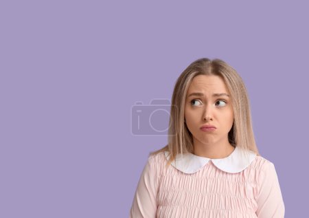 Photo for Embarrassed young woman on lilac background - Royalty Free Image