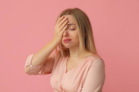 Photo for Young woman doing facepalm on pink background - Royalty Free Image