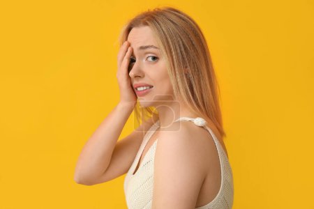 Photo for Young woman feeling shame on yellow background - Royalty Free Image