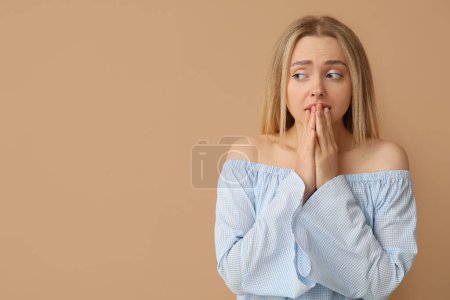 Photo for Young woman feeling shame on beige background - Royalty Free Image