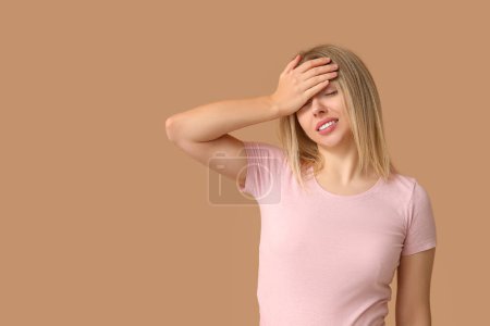Photo for Young woman doing facepalm on beige background - Royalty Free Image