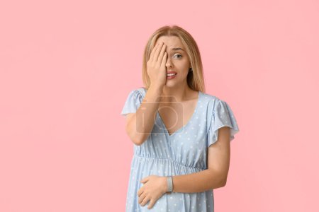 Photo for Embarrassed pregnant woman on pink background - Royalty Free Image