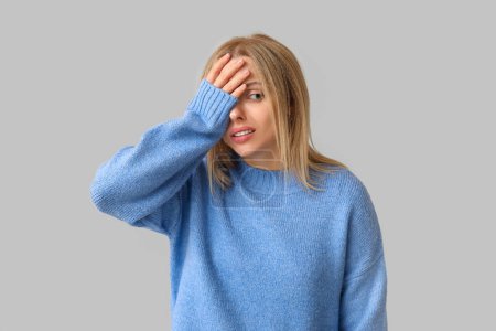 Photo for Young woman doing facepalm on grey background - Royalty Free Image