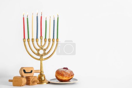 Photo for Menorah with dreidels and tasty donut isolated on white background. Hanukkah celebration - Royalty Free Image