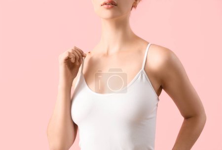 Young woman in white top on pink background