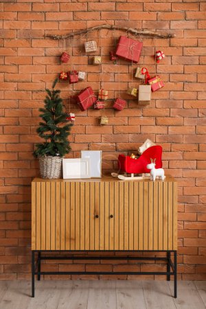 Photo for Christmas advent calendar hanging on brick wall in room - Royalty Free Image