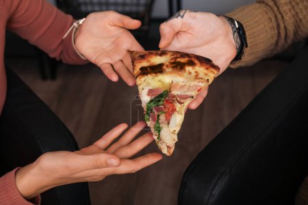 Photo for Hands with slice of tasty pizza at home, closeup - Royalty Free Image