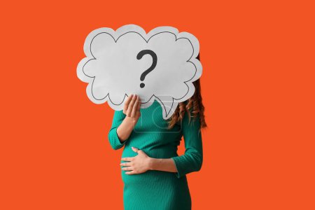 Photo for Beautiful pregnant woman holding speech bubble with question mark on orange background - Royalty Free Image