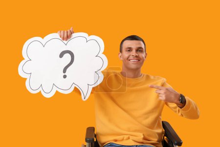 Photo for Young man in wheelchair pointing at speech bubble with question mark on yellow background - Royalty Free Image