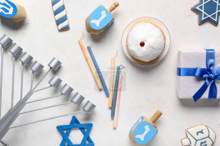 Photo for Hannukah composition with menorah, candles, donut and dreidels on white table - Royalty Free Image