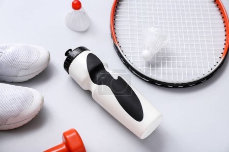 Photo for Set of sports equipment, shoes and bottle of water on light background - Royalty Free Image
