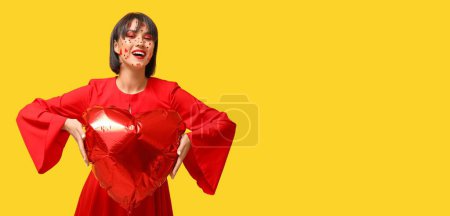 Photo for Stylish young woman with creative makeup for Valentines Day and balloon in shape of heart on yellow background with space for text - Royalty Free Image