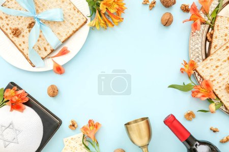 Photo for Frame made of flatbread matza, wine, Torah, kippah and alstroemeria flowers on color background - Royalty Free Image