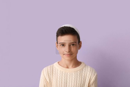 Little Muslim boy on lilac background