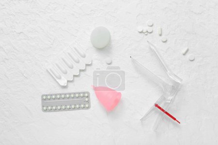 Photo for Gynecological speculum, pills, suppositories and menstrual cups on white background - Royalty Free Image
