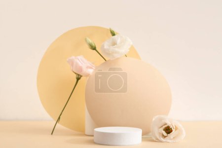 Foto de Composition with beautiful eustoma flowers and plaster podium on beige background - Imagen libre de derechos