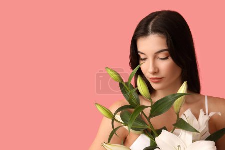 Beautiful young woman with white lily flowers on pink background, closeup