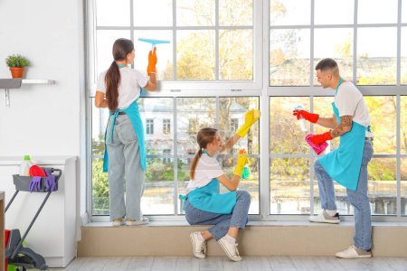 Photo for Team of young janitors cleaning window in kitchen, back view - Royalty Free Image