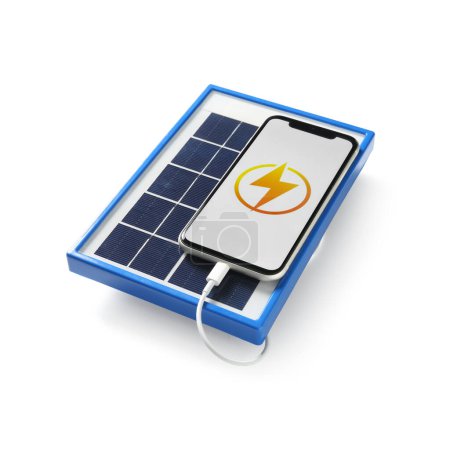 Foto de Portable solar panel charging mobile phone on white background - Imagen libre de derechos
