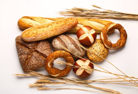 Photo for Different types of bread and wheat ears isolated on white background - Royalty Free Image