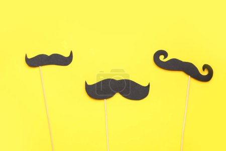 Photo for Set of paper mustaches on yellow background - Royalty Free Image