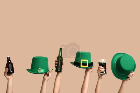 Photo for Hands with beer and leprechaun's hats on beige background. St. Patrick's Day celebration - Royalty Free Image