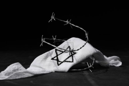 Brassard juif avec fil barbelé sur fond noir. Journée internationale de commémoration de l'Holocauste