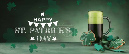 Photo for Mug of beer and cookies in shape of clover on green background. Banner for St. Patrick's Day celebration - Royalty Free Image