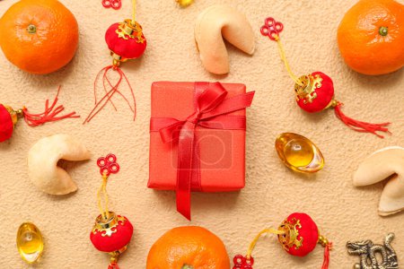 Photo for Gift box with mandarins, fortune cookies and Chinese symbols on beige background. New Year celebration - Royalty Free Image